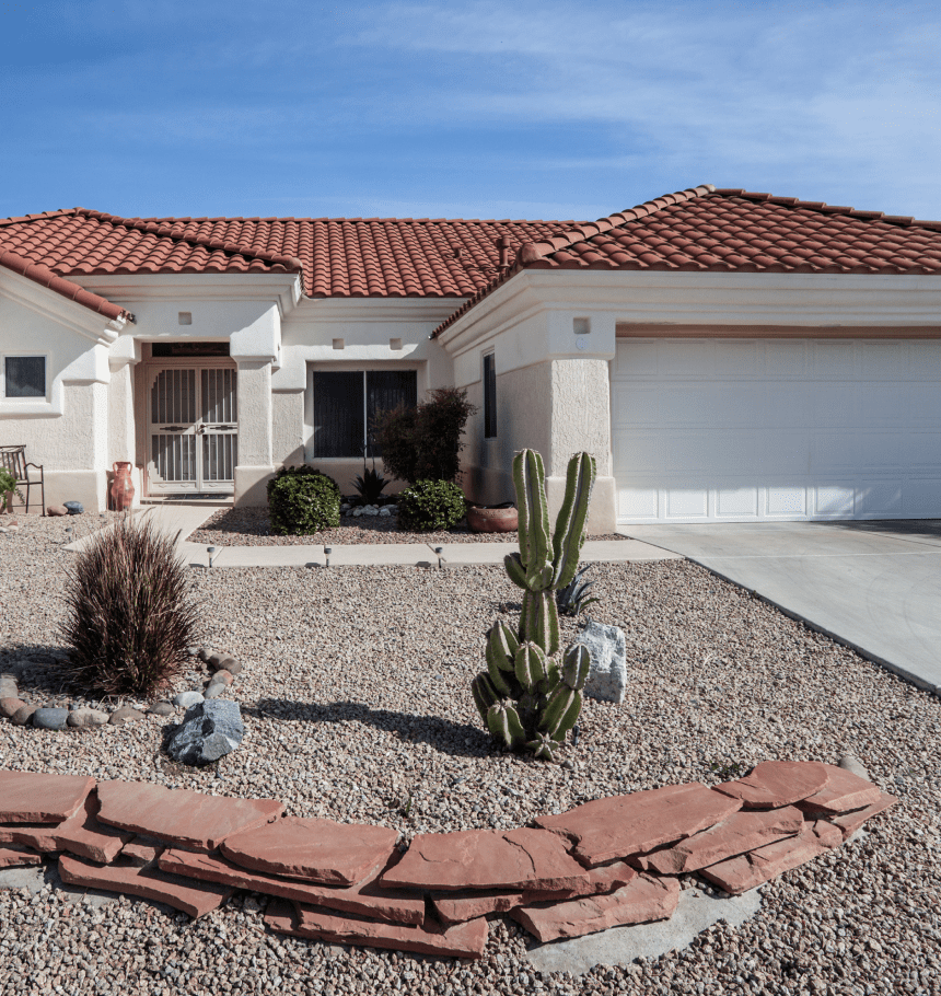 Desert landscaping, stucco house, red tile roof.