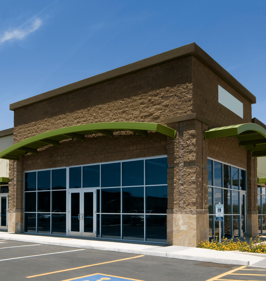 Empty storefront, brown brick building.