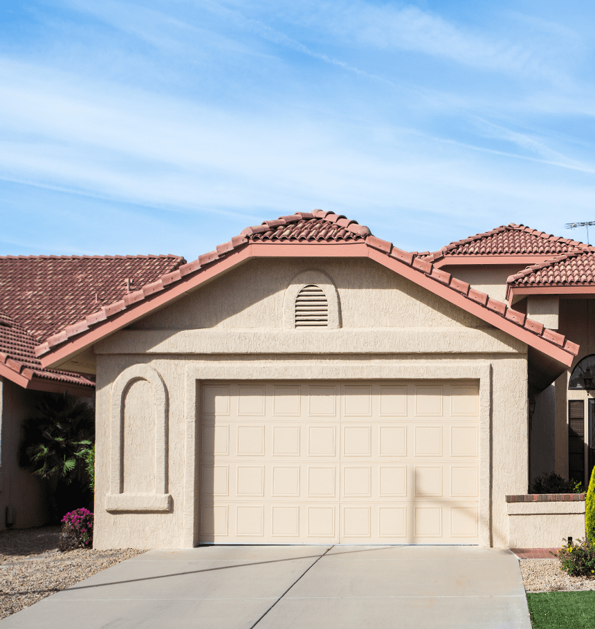 Beige garage door, terracotta roof.