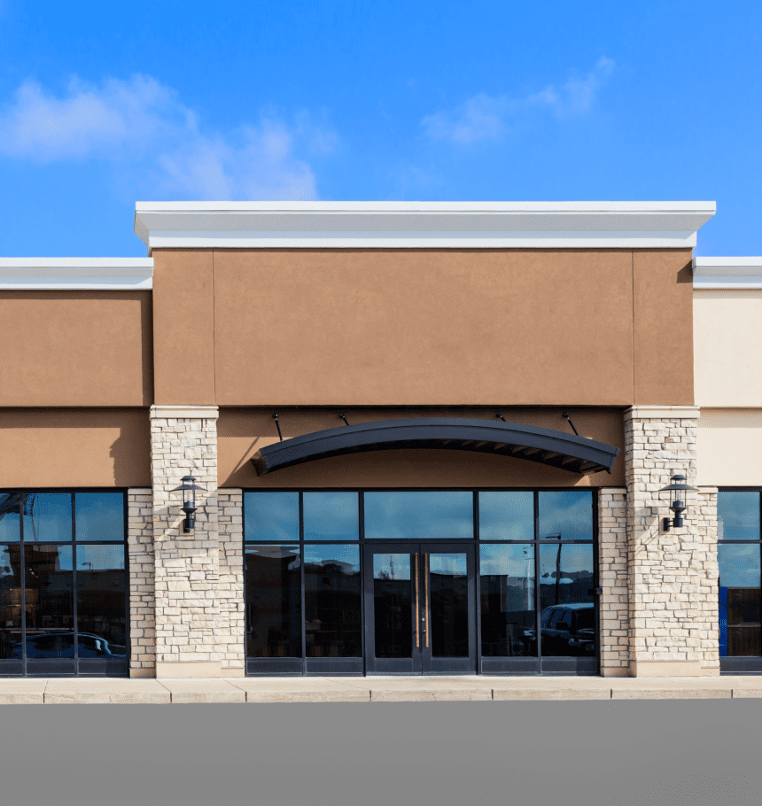 Modern storefront with large glass windows.