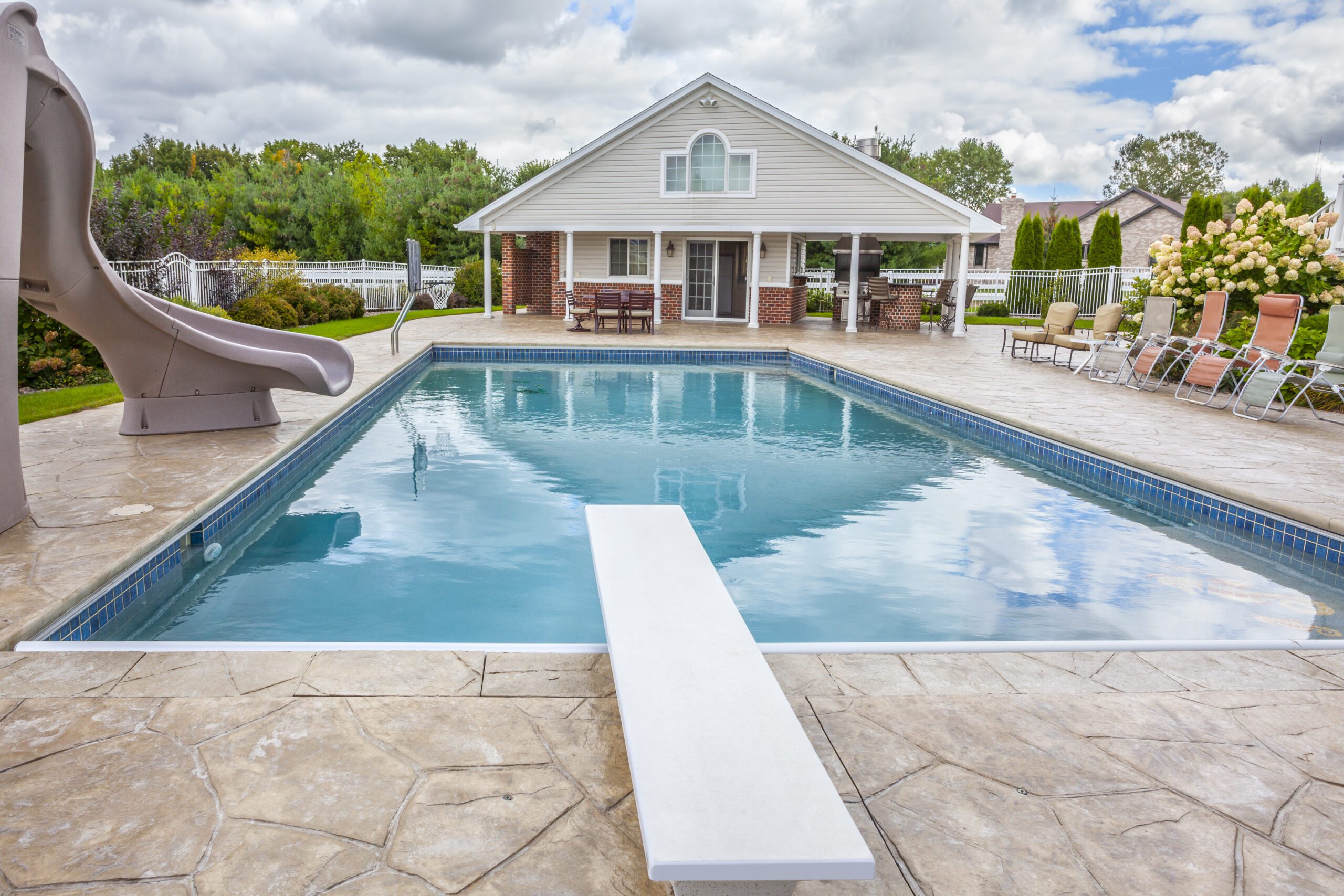 In Ground Swimming Pool with Pool-House, Slide, Diving Board.